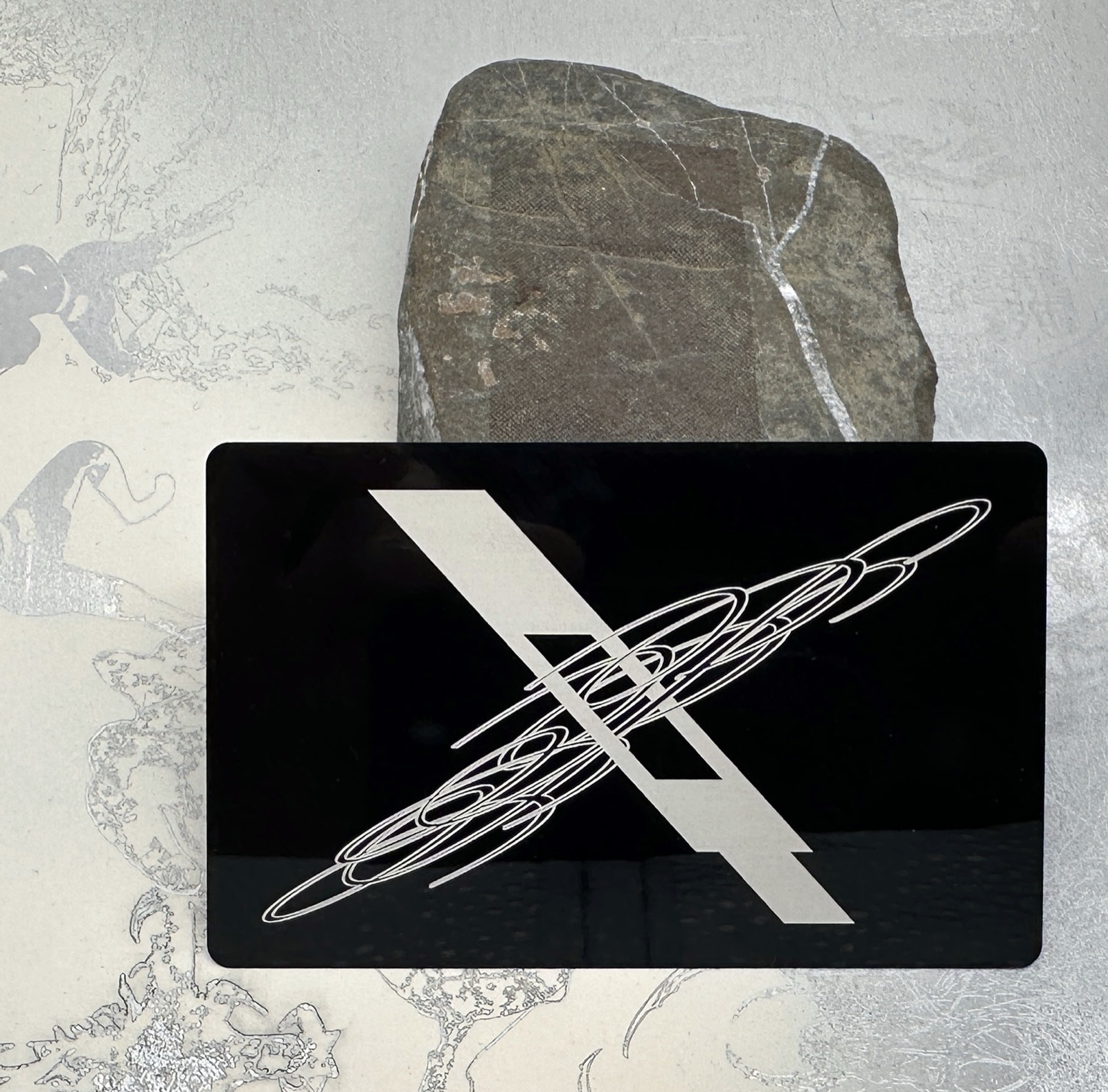 Direct Perception engraved metal business card, logo side.