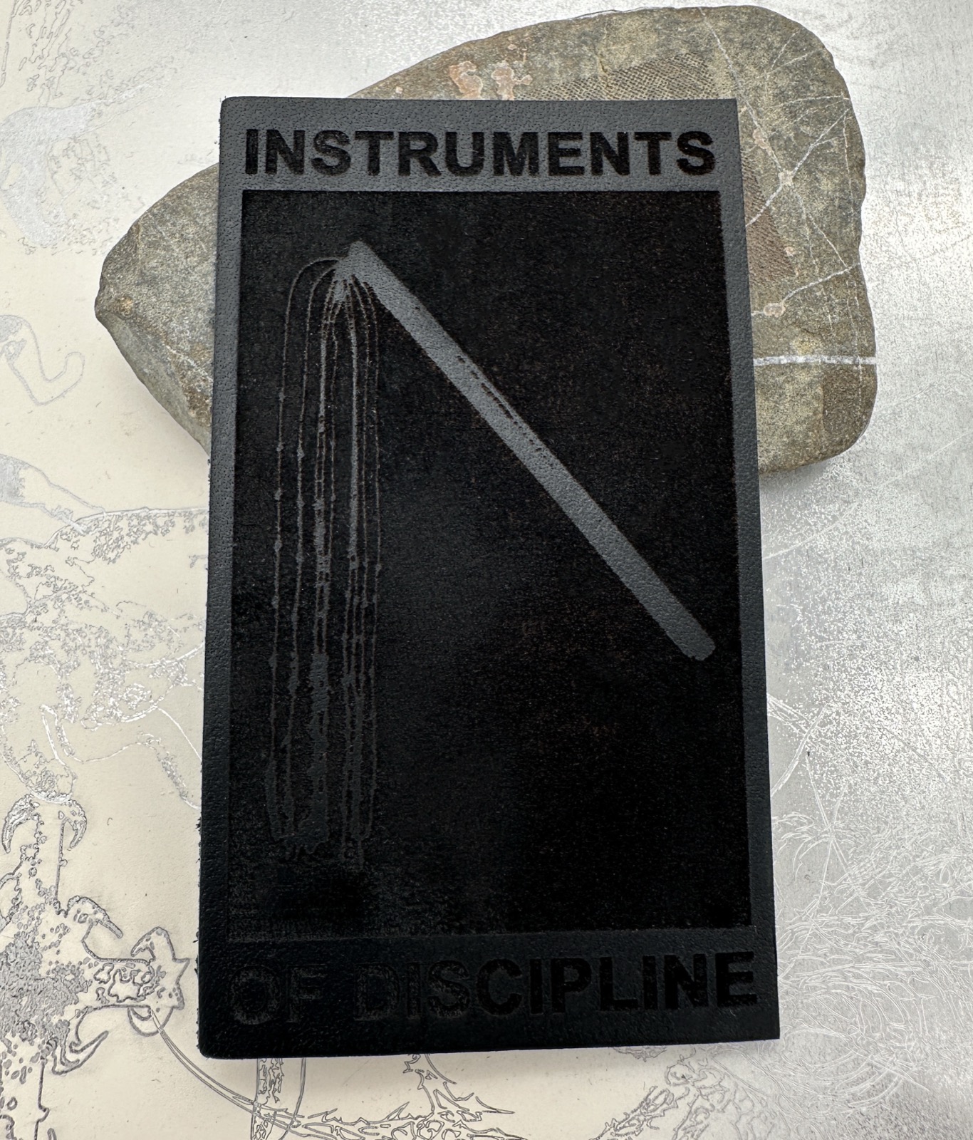 Instruments of Discipline engraved leather patch.