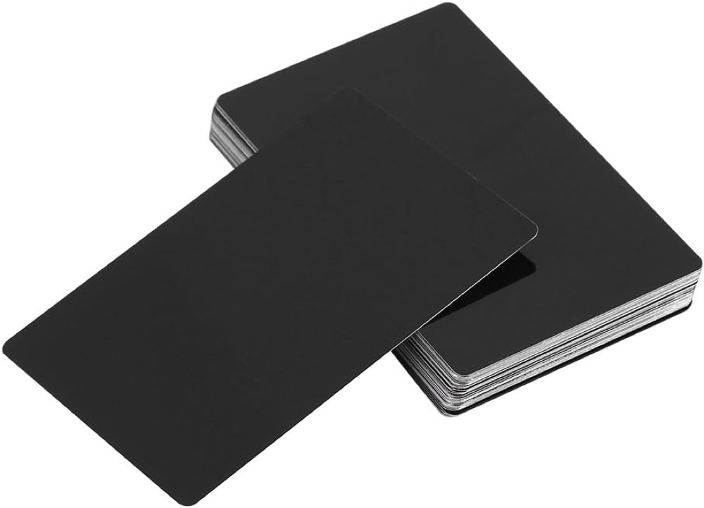 Placeholder photograph of stacked blank black metal cards.